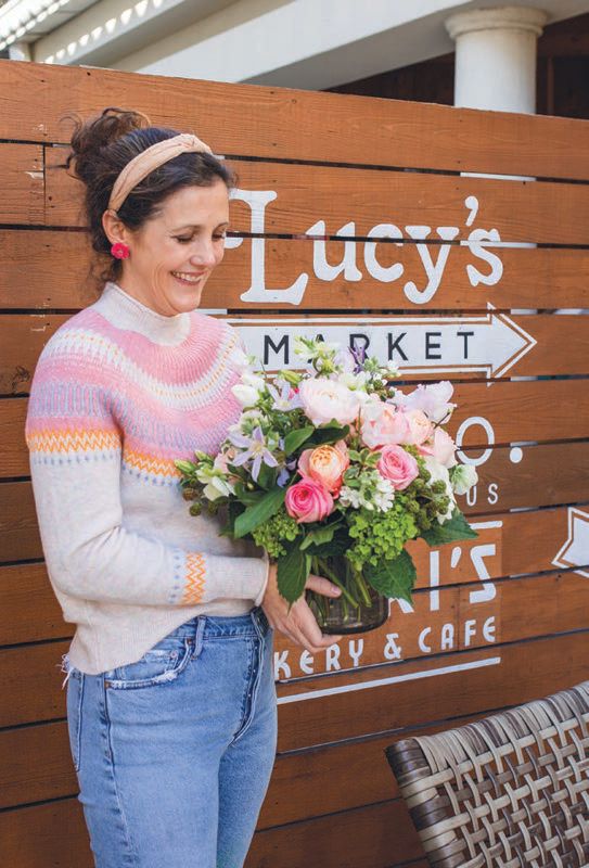 Mary Delia Poynter with a floral arrangement she designed outside Lucy’s Market in Buckhead PHOTO: COURTESY OF LUCY’S MARKET