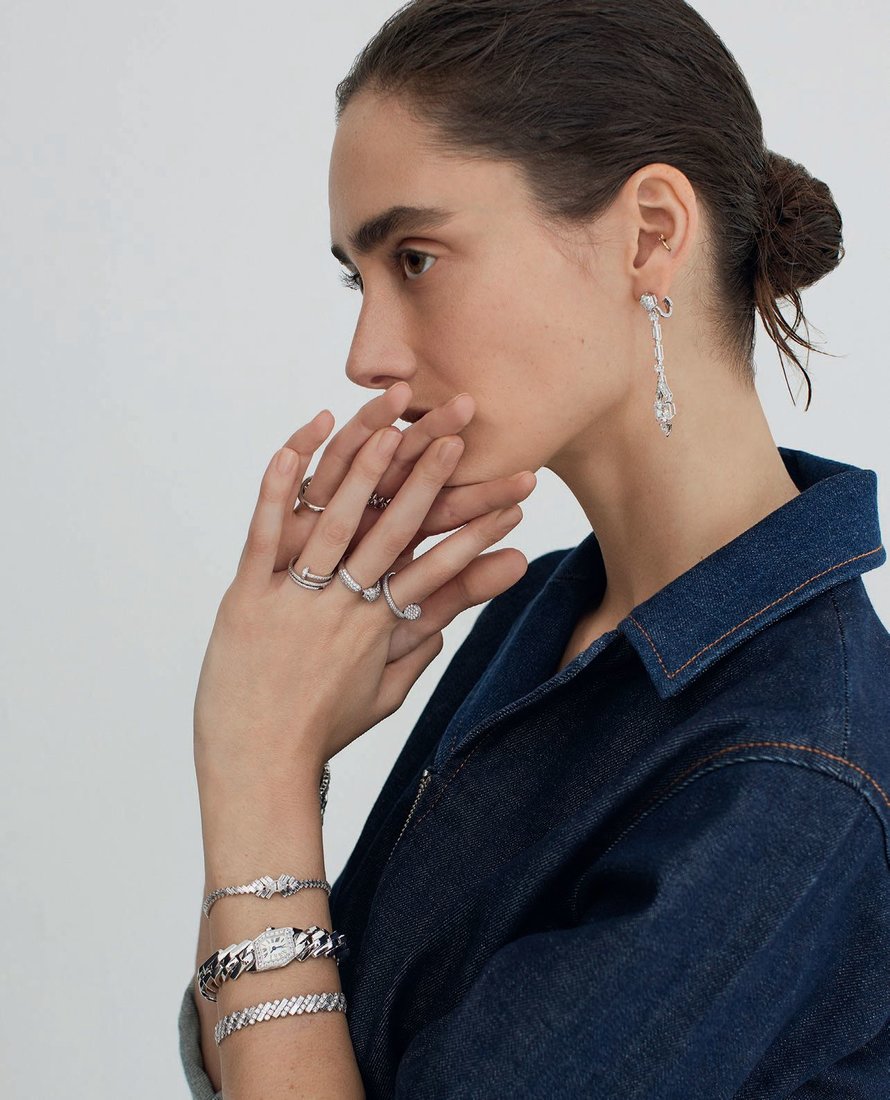 A.P.C. denim jumpsuit, apc-us.com; Cartier High Jewelry platinum earrings with diamonds, Reflection de Cartier High Jewelry 18K white gold bracelets with diamonds, Maillon de Cartier 18K white gold watch with diamonds, Juste un Clou 18K white gold rings with diamonds, La Panthère de Cartier small model 18K white gold ring with emeralds, onyx and diamonds, Juste un Clou 18K white gold ring and Clash de Cartier medium model 18K white gold ring, cartier.com. PHOTOGRAPHED BY L ARA JADE
