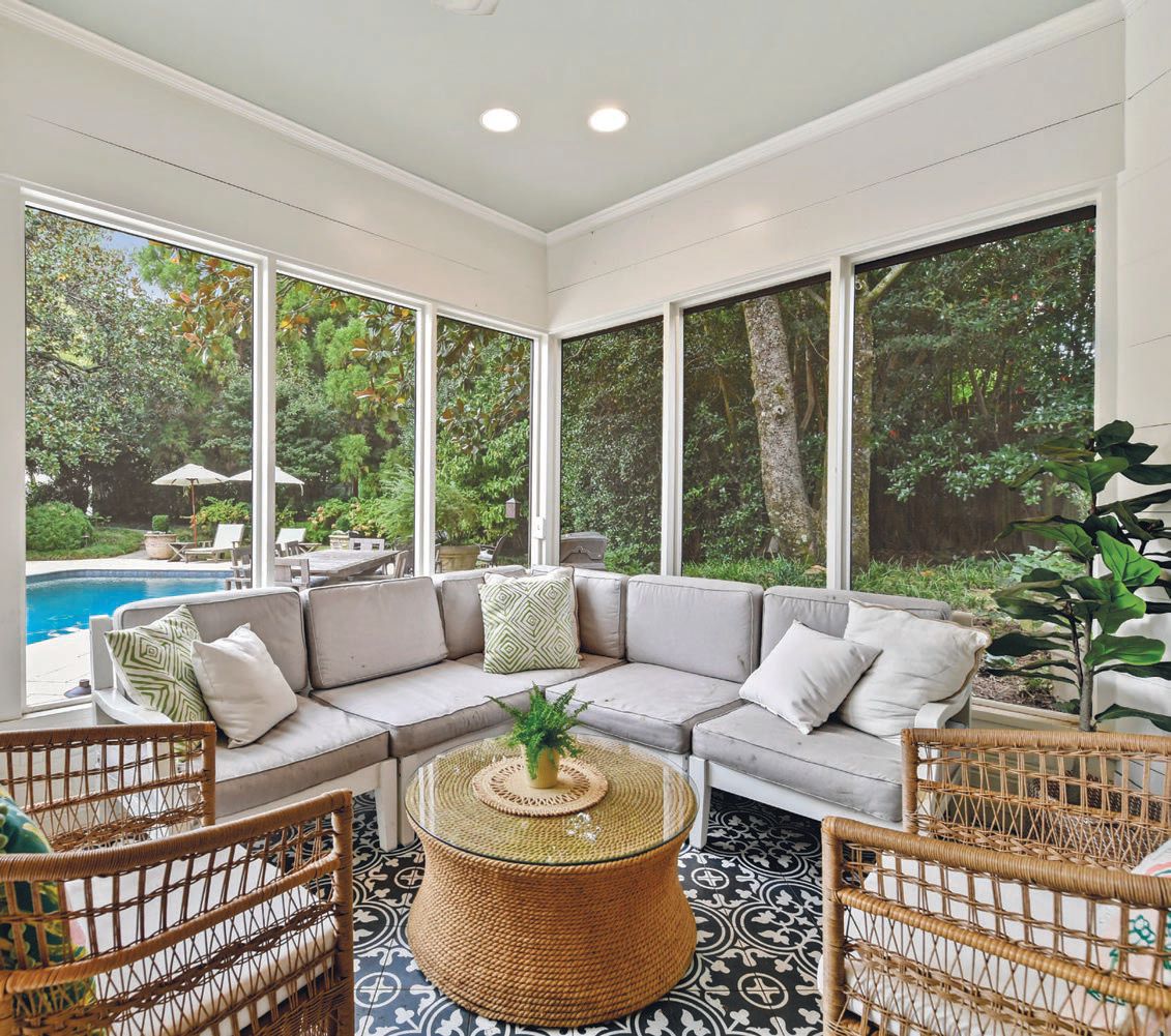 The screened-in porch overlooks the sparkling pool