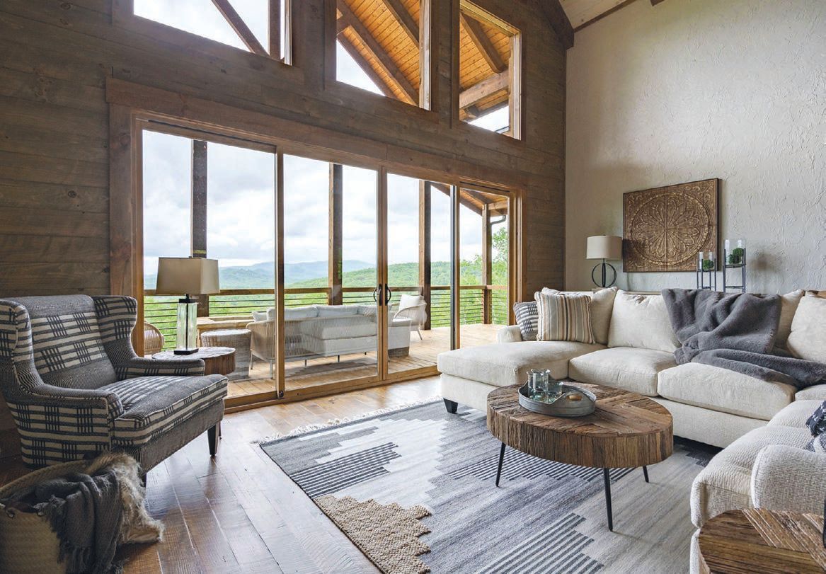 An open-concept living room with rustic wood beams and vaulted ceilings gives way to a stunning view of the Blue Ridge Mountains PHOTO: BY CHRIS NELMS/VSI GROUP