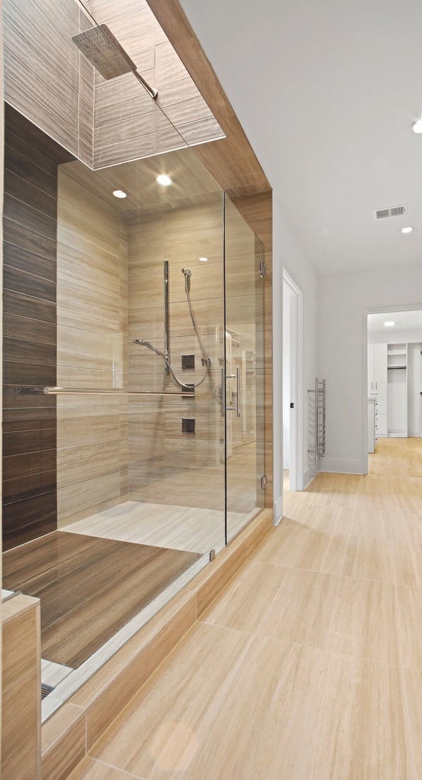 A rain showerhead, a skylight, tile by Daltile, and fixtures by Hansgrohe and Signature Hardware are a few of the Zen elements in this Dream Home master bath.