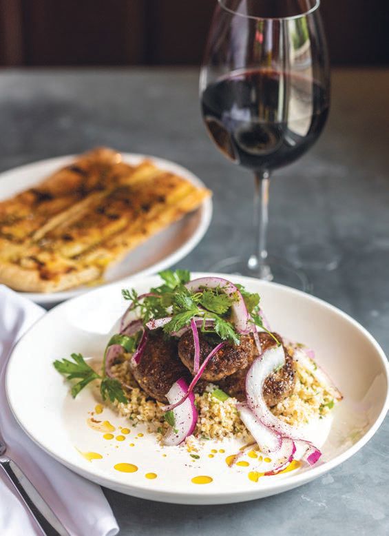 Moroccan spiced lamb skewers with garlic sesame toum, sumac onions and herb salad. PHOTO BY: HEIDI HARRIS PHOTOGRAPHY