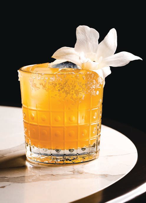 The spicy margarita is topped with fresh florals and rose water. PHOTO COURTESY OF WALDORF ASTORIA ATLANTA BUCKHEAD