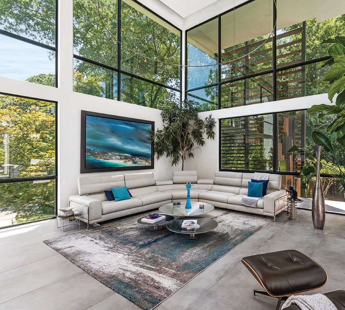 The living room features a whole wall of glass windows PHOTO BY JOSHUA BARTOLOTTI