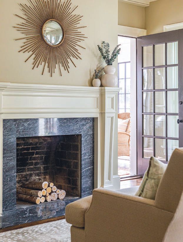 Just as with the screened-in porch, the primary suite’s sitting room also features a lovely wood-burning fireplace.