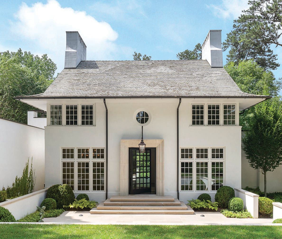 The symmetrical front of the home features a sunken courtyard PHOTO COURTESY OF ANSLEY REAL ESTATE