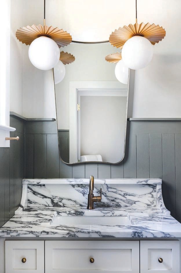 Greyson’s en suite bathroom features fun fluted pendants instead of the expected sconce. Photographed by Samantha Wittman
