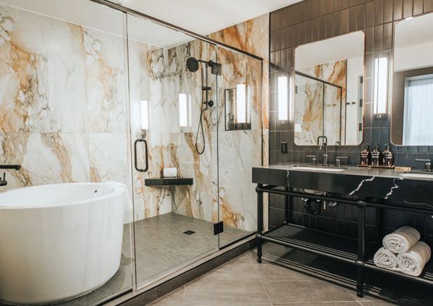 The suite’s grand bathroom features ample space, marble and a large Japanese soaking tub PHOTO BY CALEB JONES PHOTOGRAPHY